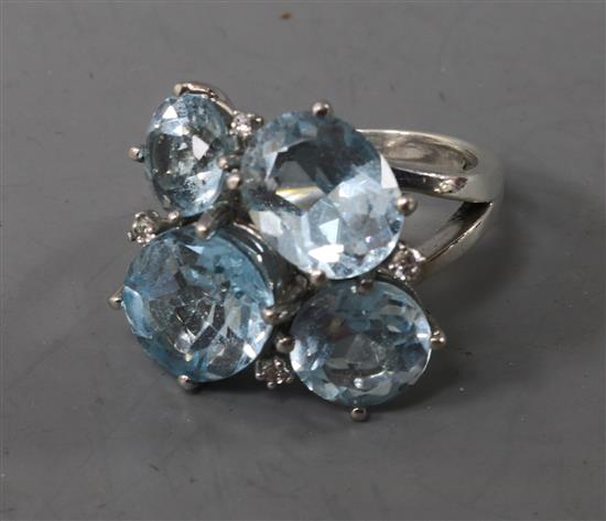 A silver, blue topaz and colourless stone set dress ring, size L.